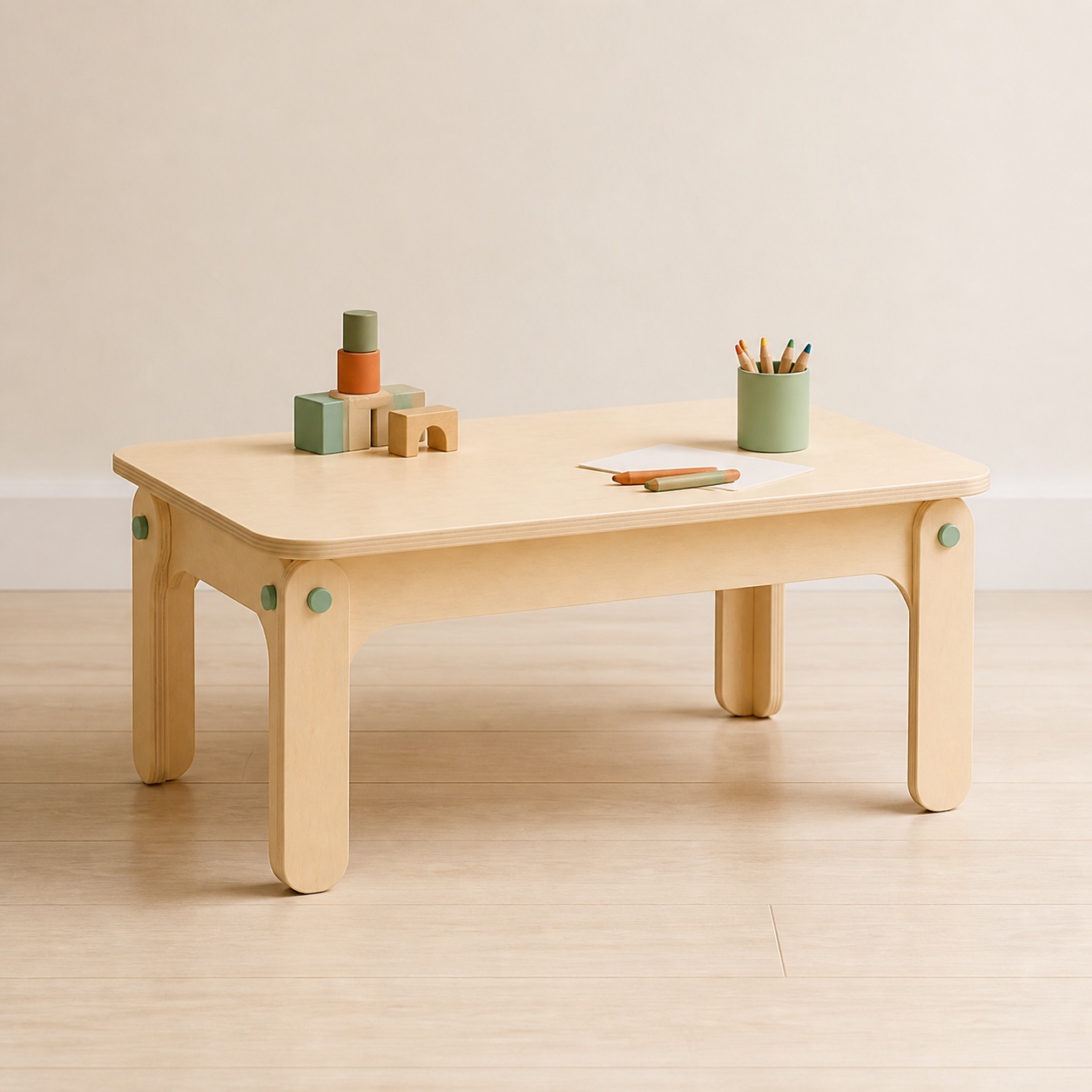A low rounded wooden activity table with blocks and crayons.