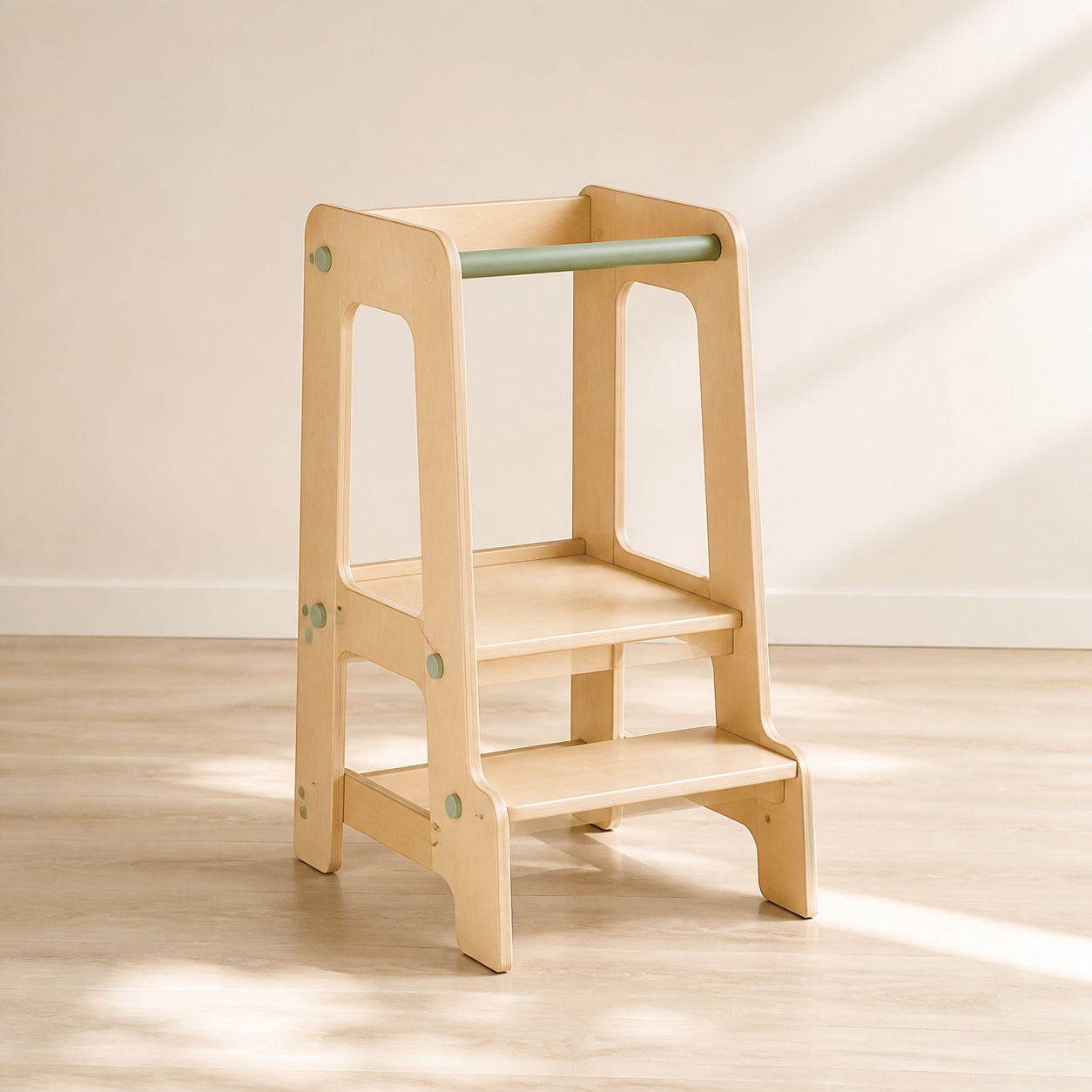 A light-wood toddler tower with a step platform and sage guard rail.